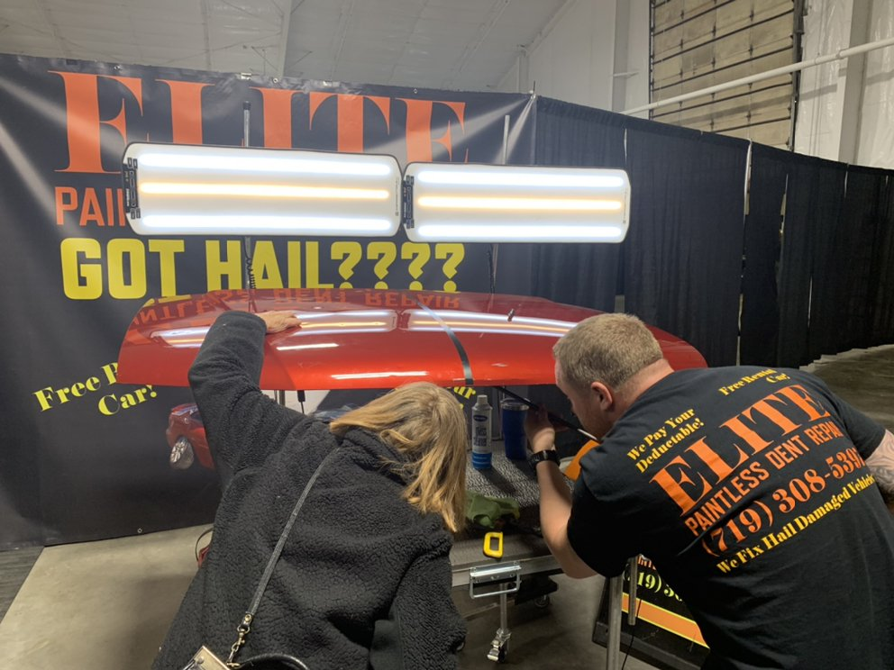Elite Paintless Dent Repair team working on a hail-damaged vehicle