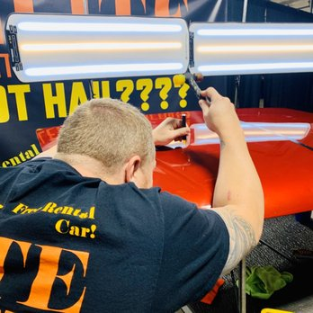 Elite technician performing hail damage repair